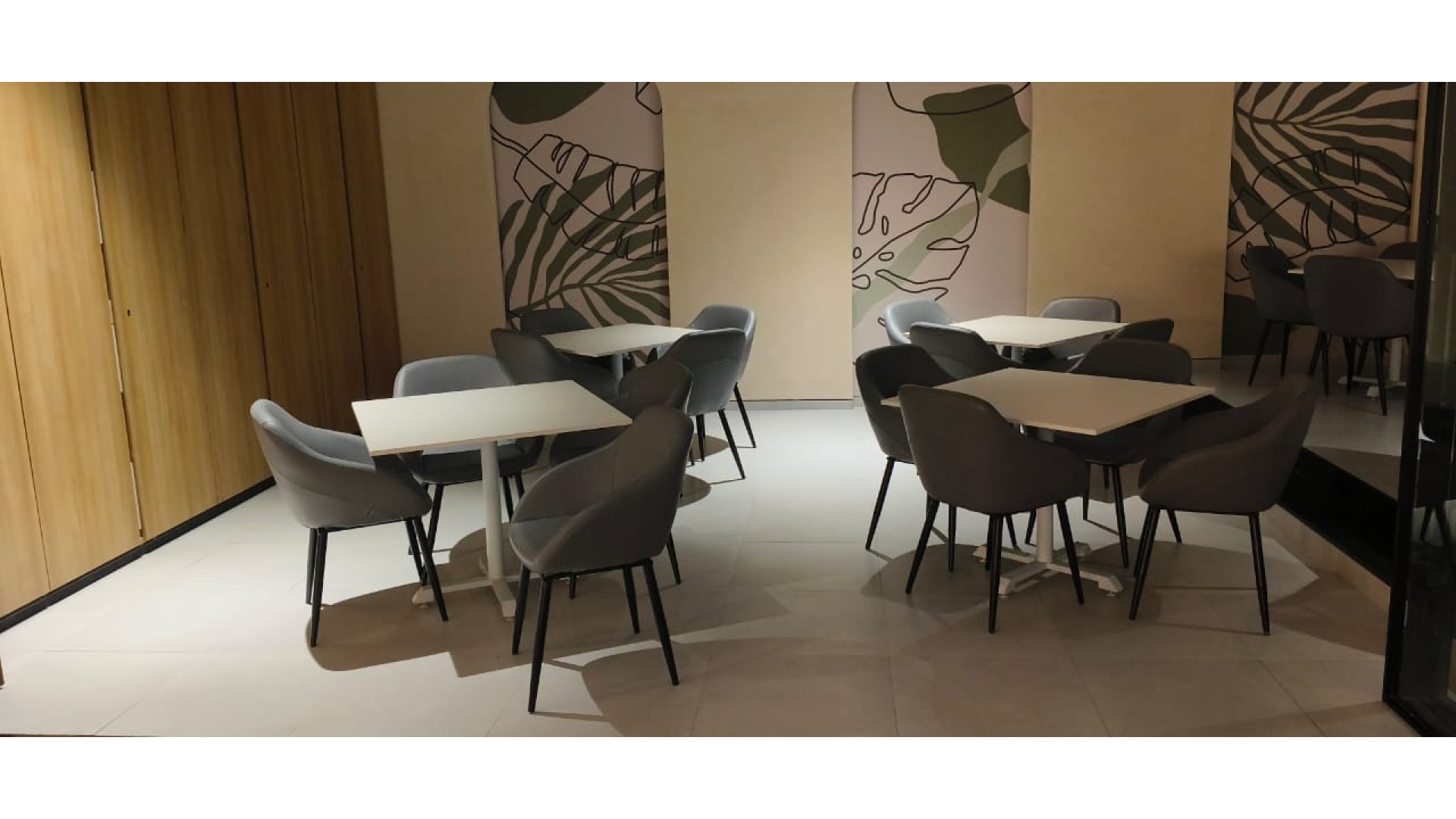 Intimate Cafe Seating Nook with Slate Gray Tub Chairs & Timber Cladding